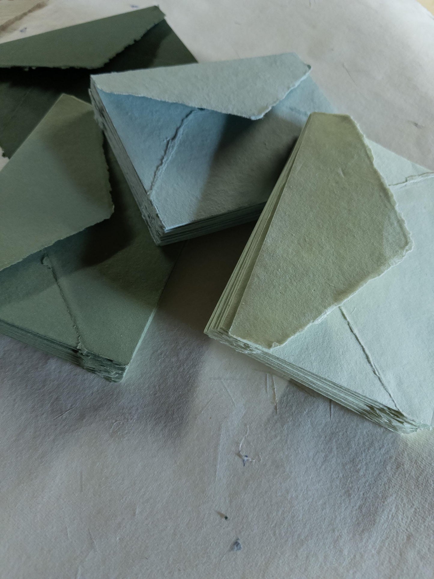Beautiful forest green deckle edge envelope created with eco-friendly cotton rag paper - a sophisticated choice for luxury stationery