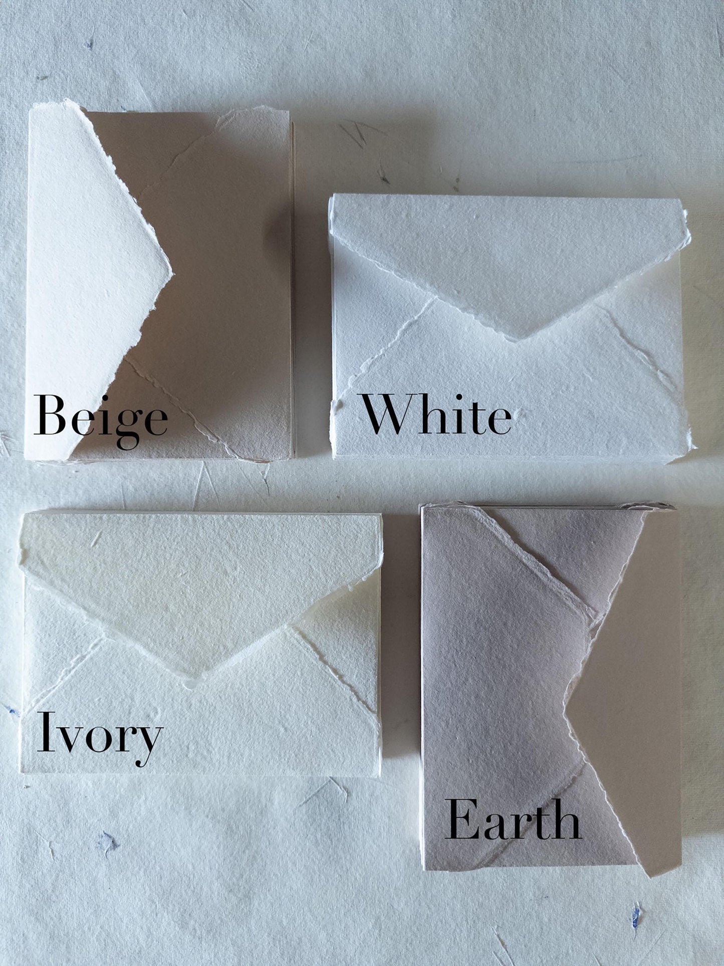 Earth-toned paper and envelopes in various sizes, featuring a natural deckle edge, crafted from artisanal cotton rag material - perfect for nature-inspired stationery