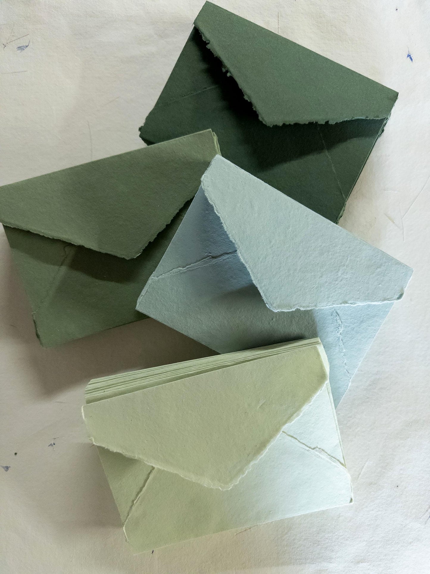 Handmade olive green deckle edge envelope crafted from premium cotton rag paper - perfect for rustic and nature-inspired stationery.