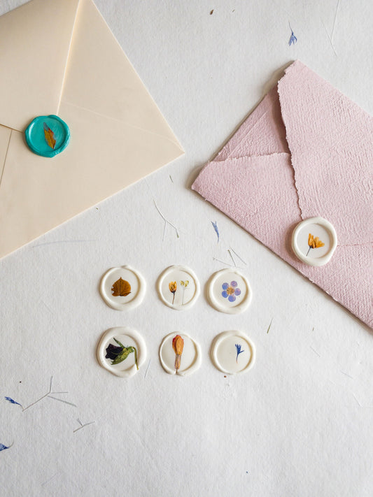 Set of assorted wax seals in various colors, each adorned with a real pressed flower - ideal for enhancing your stationery and crafting projects