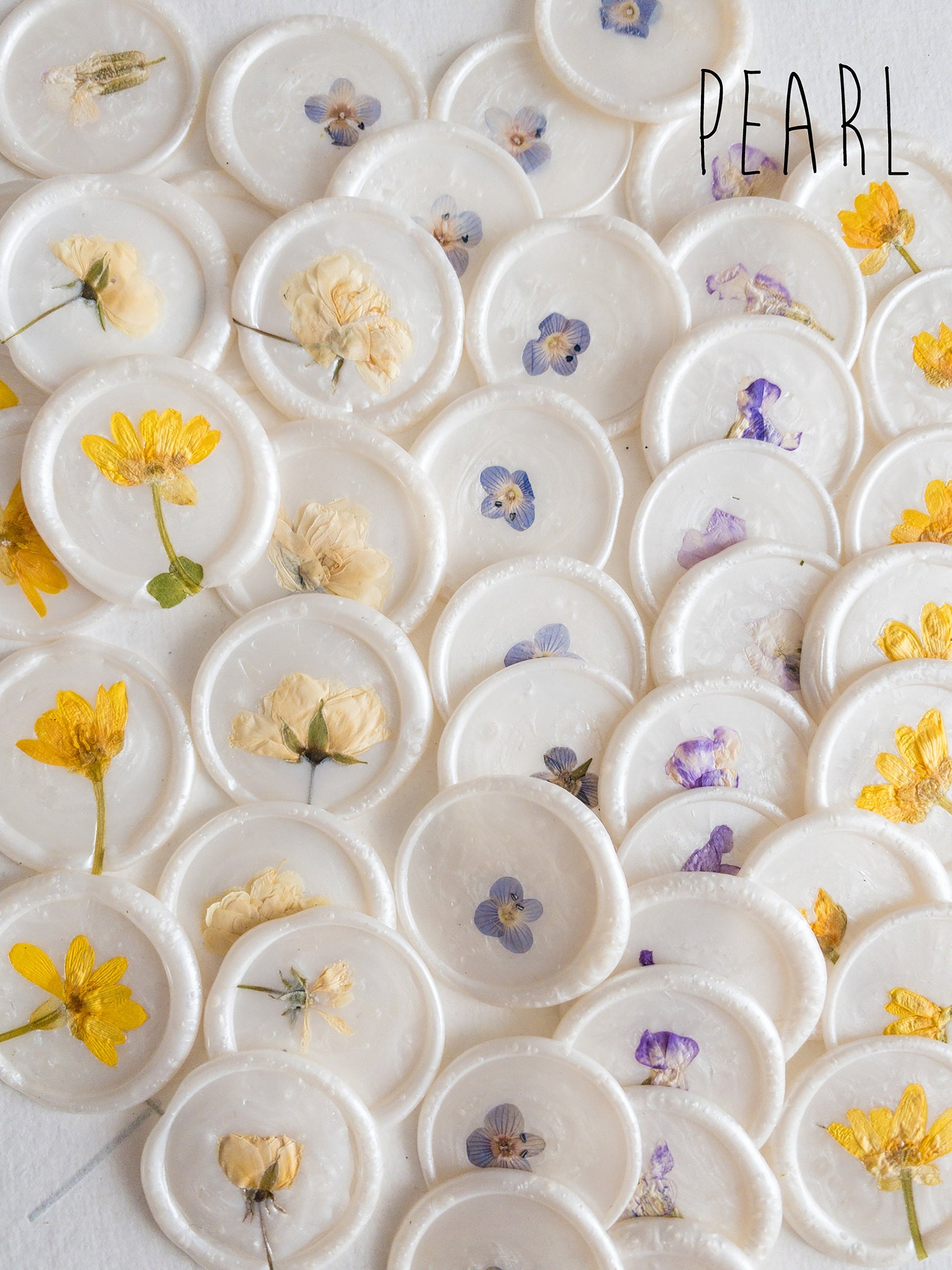 Handmade wax seal in a pearl color, featuring a pressed flower - an exquisite addition to your sealing wax collection
