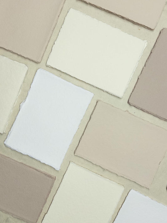 Handmade ivory paper and envelopes in various sizes, featuring a natural deckle edge, made from premium cotton rag material - ideal for luxurious stationery needs